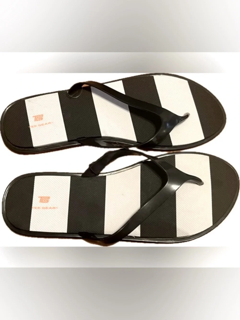 Tek Gear black and white flip flops. New with tag. Women’s size L (9-10)